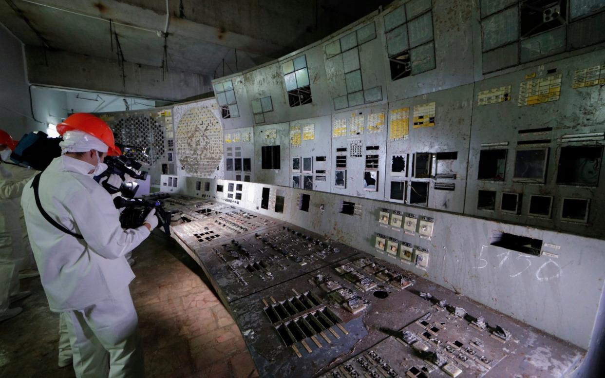 Journalists film in the control room of Chernobyl reactor four, where the test was launched that led to the worst nuclear disaster in history - REX