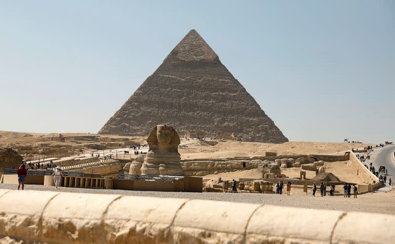 Tourists visit the Sphinx and the Great Pyramids of Giza, on the outskirts of Cairo