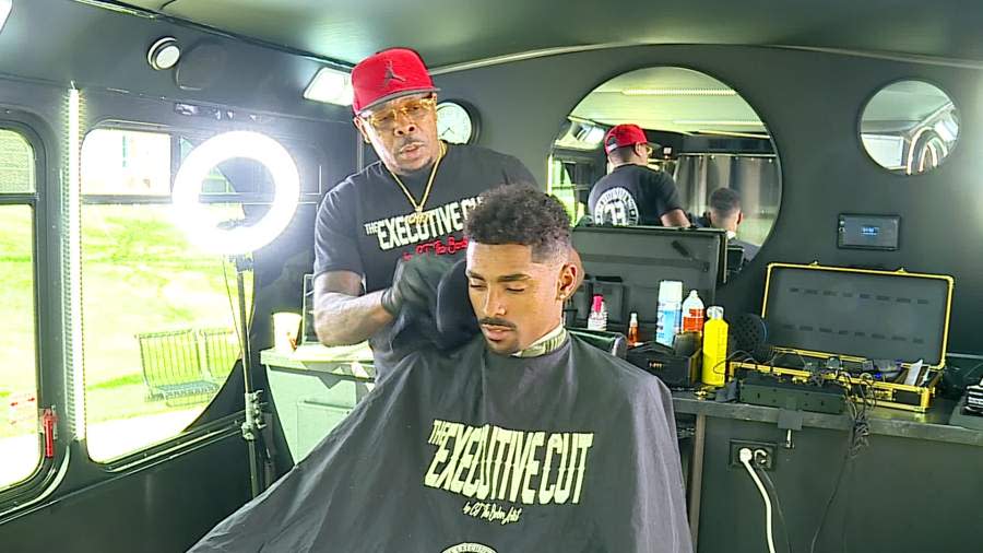 Cecil "CJ" Jackson, barber and owner of The Executive Cut in Grand Rapids brings a mobile barbershop to GVSU's Allendale Campus. (April 8, 2024)