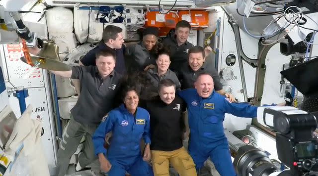 <p>NICHOLAS KAMM/NASA/AFP via Getty</p> Suni Williams and Butch Wilmore pose with the crew of the International Space Station