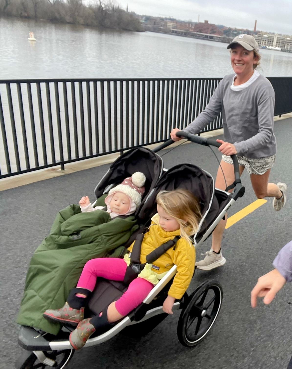 Detroit Free Press marathon entrant Jessie Stewart, 39, runs while pushing a stroller with 3-year-old daughter Avi Mae’s hair flying as son Jack, 1, snoozes during a recent workout near their home in Oakland, California.