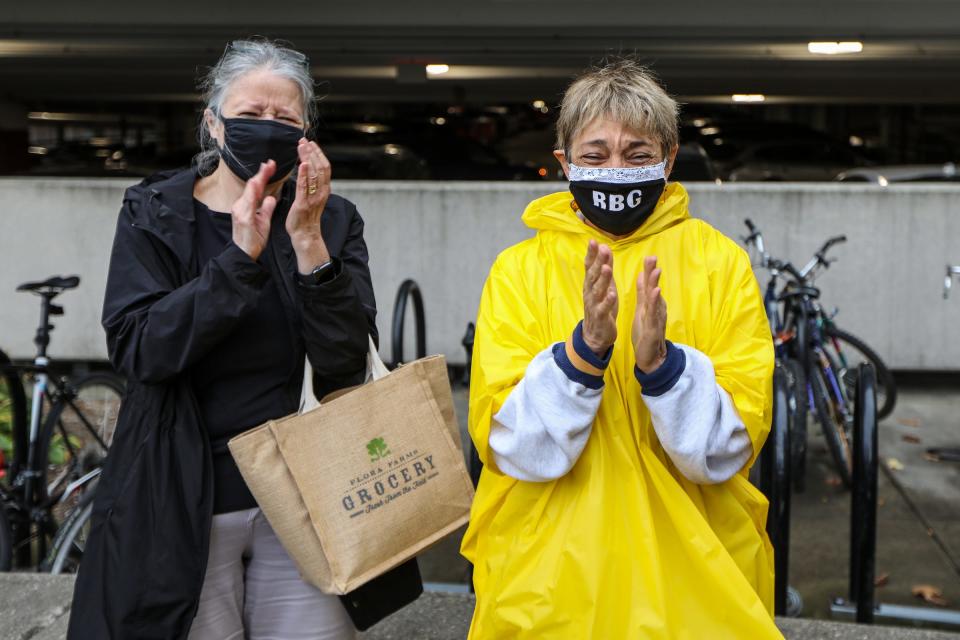 Deanna Hair's family and friends hold back tears as they gather in front of the University of Michigan hospital in Ann Arbor, Mich. to give her a surprise send-off after battling COVID-19 for 196 days in the hospital on  Oct. 15, 2020.