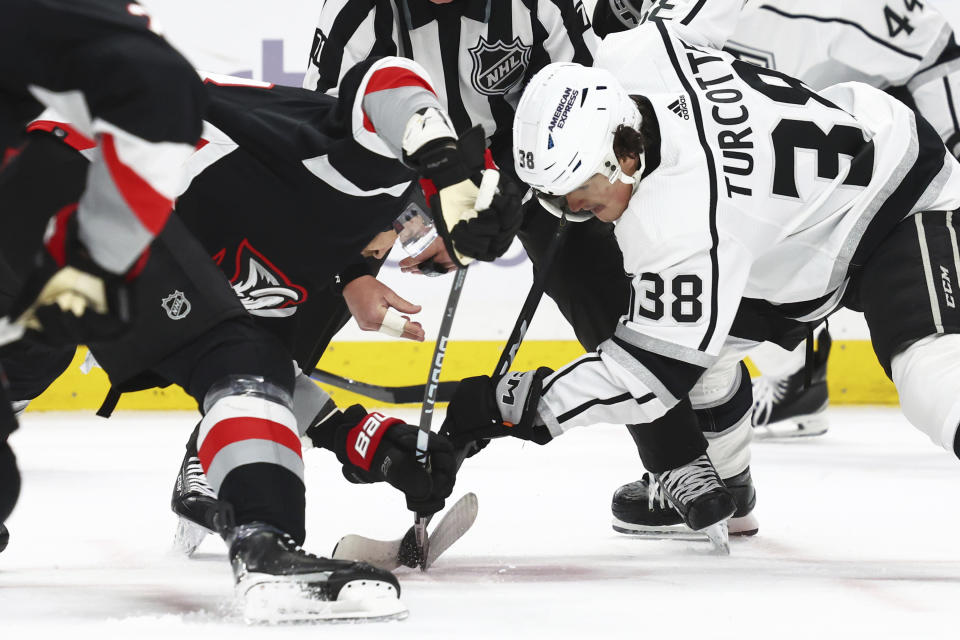 Buffalo Sabres left wing Zemgus Girgensons (28) and Los Angeles Kings center Alex Turcotte (38) vie for the puck on a faceoff during the first period of an NHL hockey game Tuesday, Feb. 13, 2024, in Buffalo, N.Y. (AP Photo/Jeffrey T. Barnes)