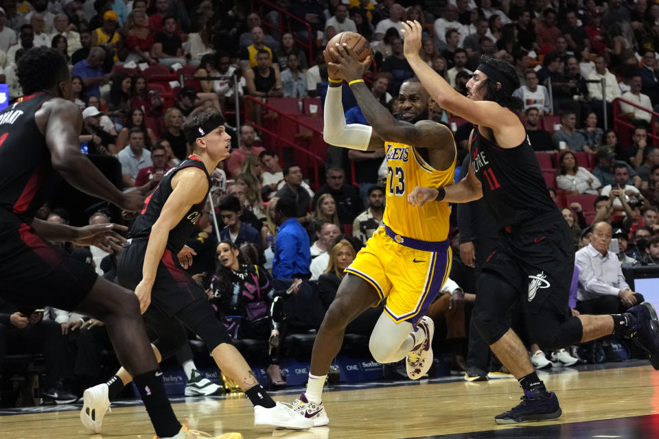 Los Angeles Lakers forward LeBron James (23) drives to the basket as Miami Heat guard Jaime Jaquez Jr. (11) defends during the first half of an NBA basketball game, Monday, Nov. 6, 2023, in Miami. (AP Photo/Lynne Sladky)