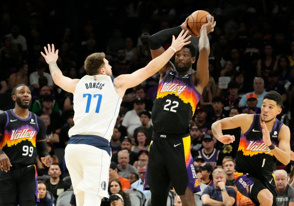 May 15, 2022; Phoenix, Arizona, USA; Dallas Mavericks guard Luka Doncic (77) pressures Phoenix Suns center Deandre Ayton (22) during game seven of the second round for the 2022 NBA playoffs at Footprint Center.