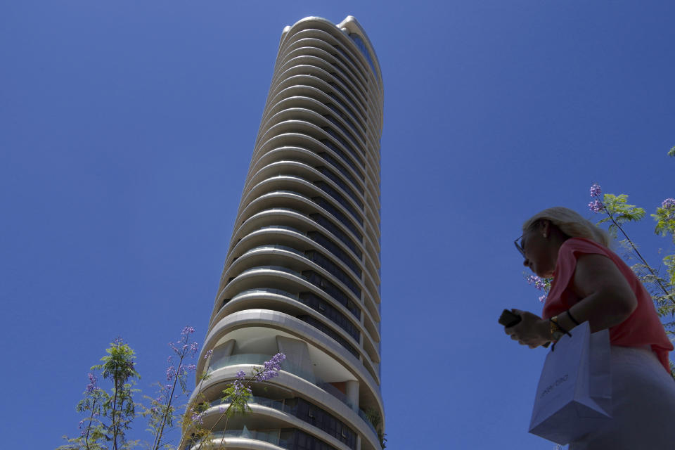 A woman walks by a new tower at a main shopping street in capital Nicosia in the eastern Mediterranean island of Cyprus, on Wednesday, June 7, 2023. When the U.S. and U.K. in April included a handful of Cypriot nationals and Cyprus-registered companies as part of another global crackdown on 'enablers' helping Russian oligarchs skirt sanctions, the perception that the island nation somehow remains Moscow's financial lackey again loomed large. (AP Photo/Petros Karadjias)