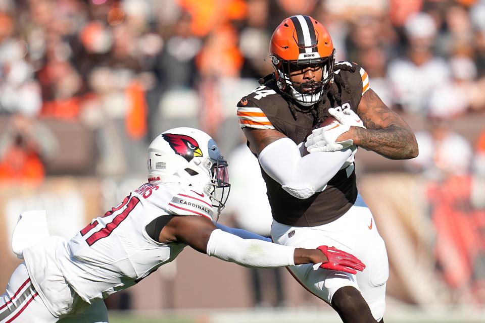 Cleveland Browns tight end Jordan Akins, right, runs against Arizona Cardinals cornerback Garrett Williams during the first half Nov. 5 in Cleveland.