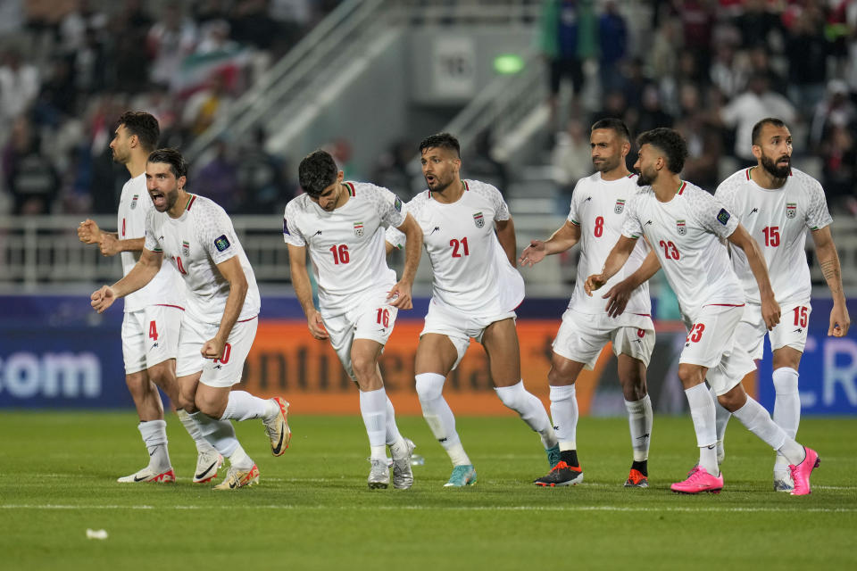 Iran players celebrate after a penalty shootout at the end of the Asian Cup Round of 16 soccer match between Iran and Syria, at Abdullah Bin Khalifa Stadium in Doha, Qatar, Wednesday, Jan. 31, 2024. (AP Photo/Aijaz Rahi)