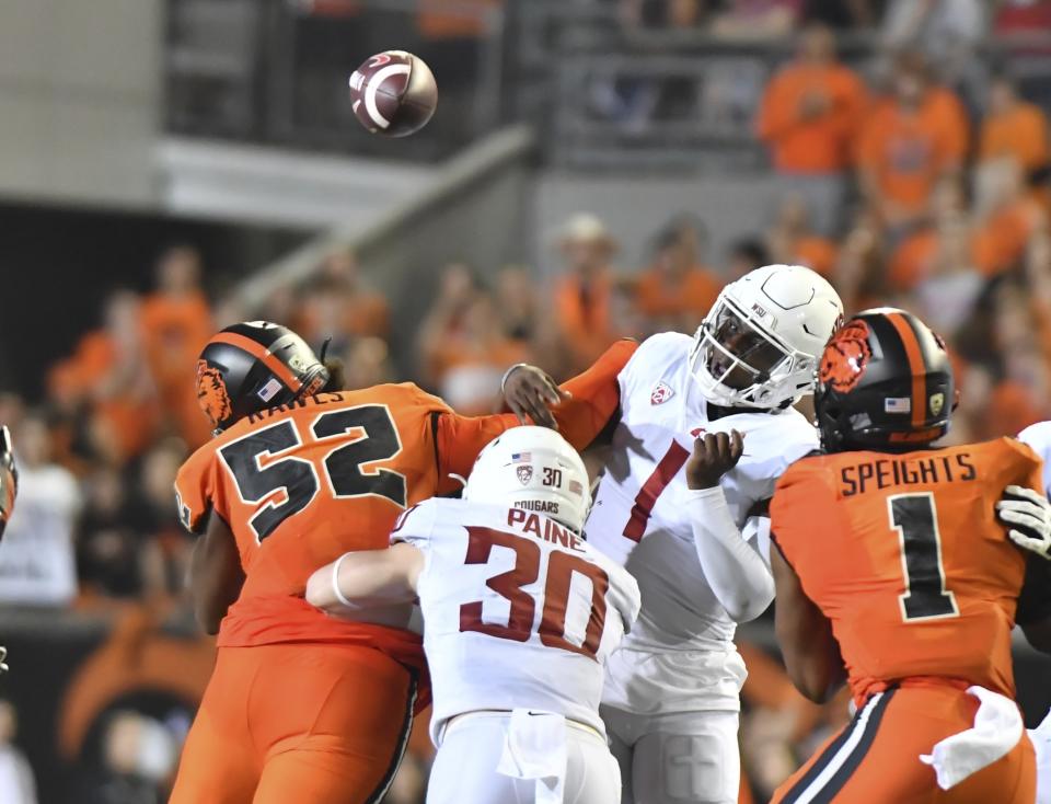 Oregon State defensive lineman James Rawls hits Washington State quarterback Cameron Ward forcing an interception during the second half of an NCAA college football game Saturday, Oct. 15, 2022, in Corvallis, Ore. (AP Photo/Mark Ylen)