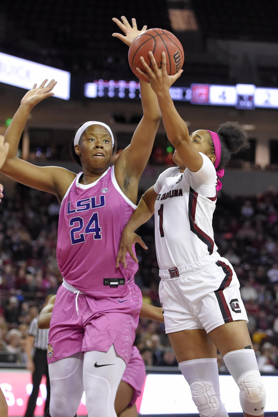 South Carolina's Zia Cooke (1) shoots while defended by LSU's Faustine Aifuwa during the first half of an NCAA college basketball game Thursday, Feb. 20, 2020, in Columbia, S.C. (AP Photo/Richard Shiro)