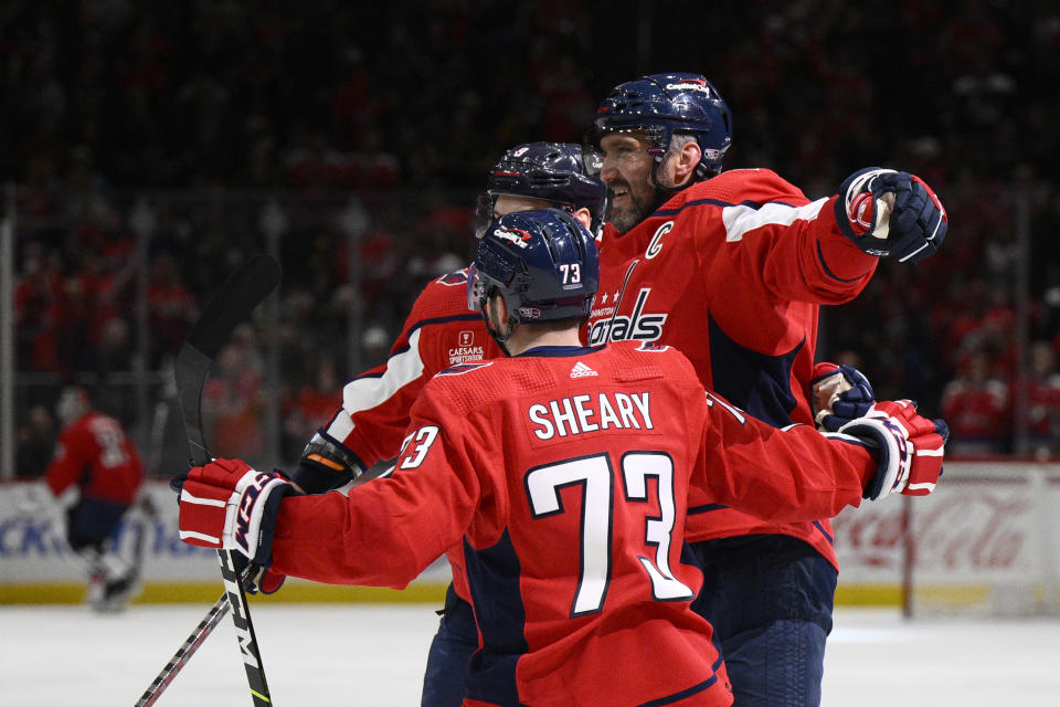 Washington Capitals left wing Alex Ovechkin, right, celebrates his goal against the Pittsburgh Penguins with defenseman Dmitry Orlov (9) and left wing Conor Sheary (73) during the first period of an NHL hockey game Thursday, Jan. 26, 2023, in Washington. (AP Photo/Nick Wass)