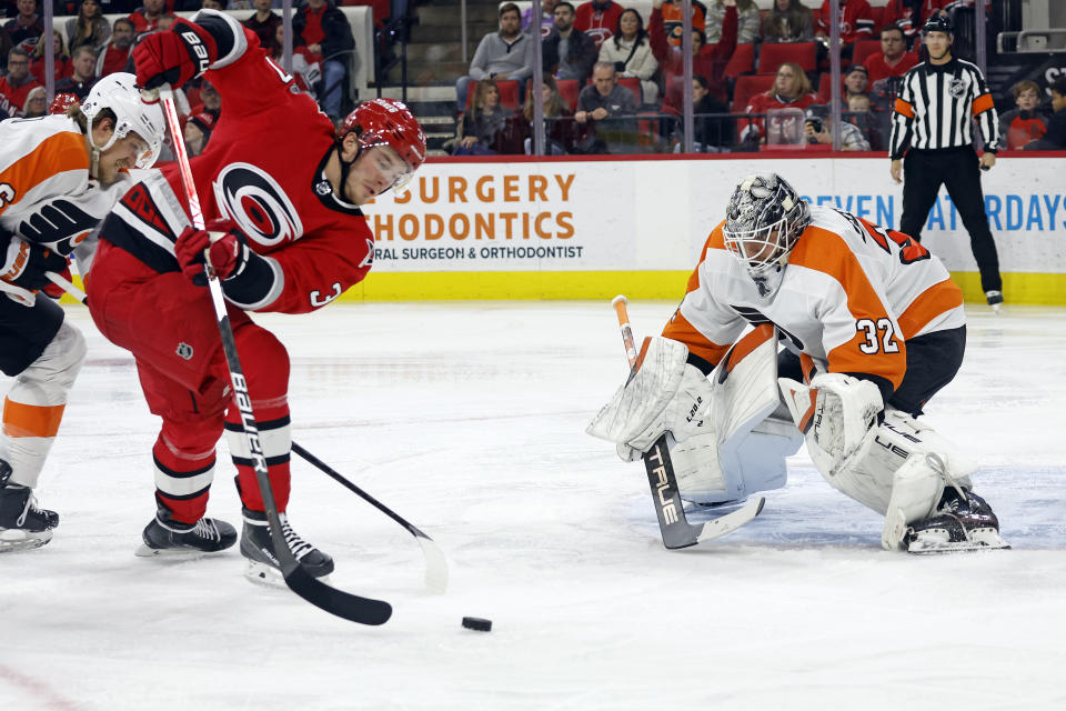 Carolina Hurricanes' Andrei Svechnikov (37) attempts to shoot the puck at Philadelphia Flyers goaltender Felix Sandstrom (32) during the second period of an NHL hockey game in Raleigh, N.C., Thursday, March 9, 2023. (AP Photo/Karl B DeBlaker)