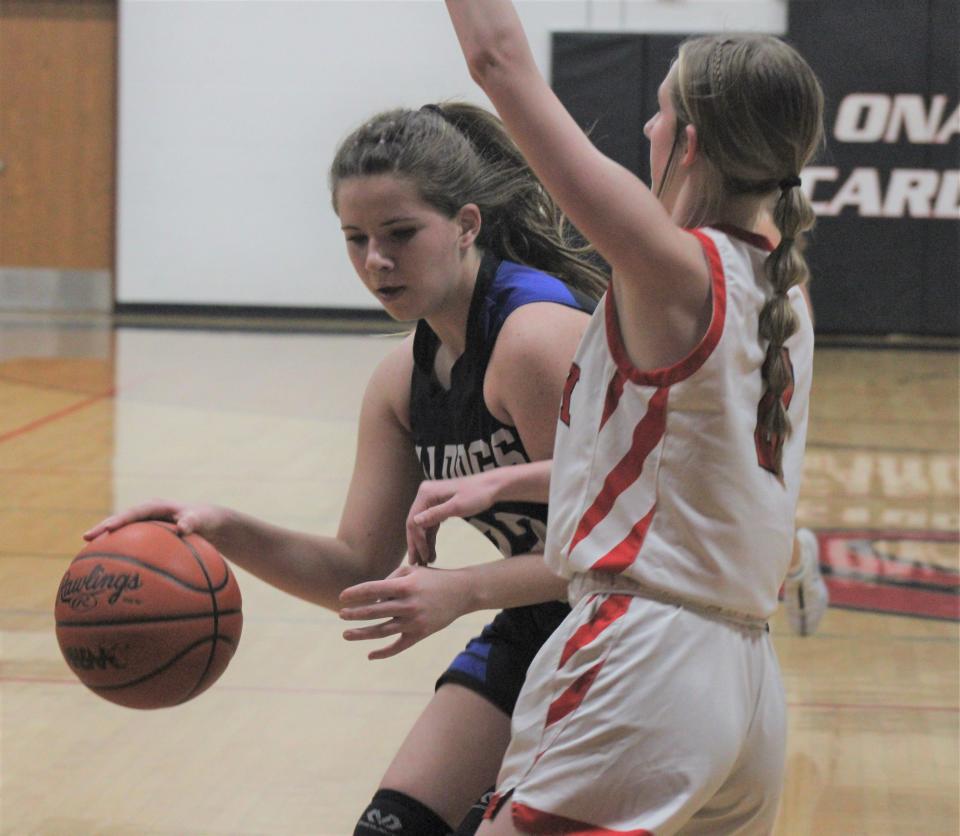 Inland Lakes sophomore Chloe Robinson (left) attempts to get past Onaway junior defender Sadie Decker during the second half of Friday's district final at Onaway.