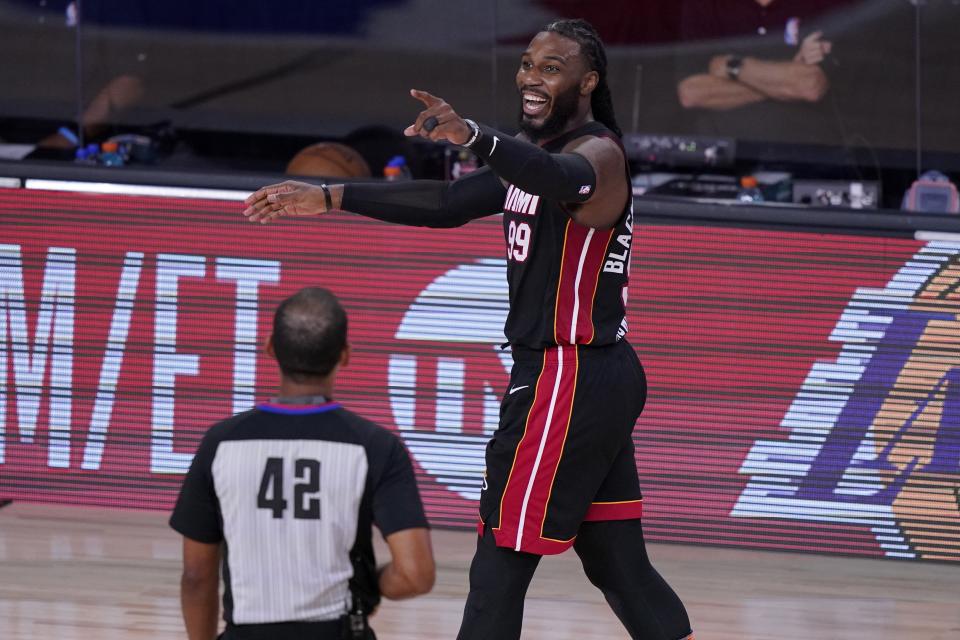 Referee Eric Lewis (42) looks on as Miami Heat's Jae Crowder (99) smiles after fouling the Boston Celtics on a shot attempt during the second half of an NBA conference final playoff basketball game, Saturday, Sept. 19, 2020, in Lake Buena Vista, Fla. (AP Photo/Mark J. Terrill)