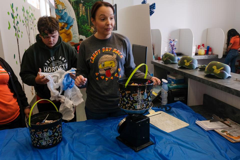 Staff members weigh returned Halloween candy during the Amarillo Pediatrics Dentistry and Orthodontics candy buy back event in 2021. As with last year's event, the candy collected this week will be shipped to military troops stationed around the world.