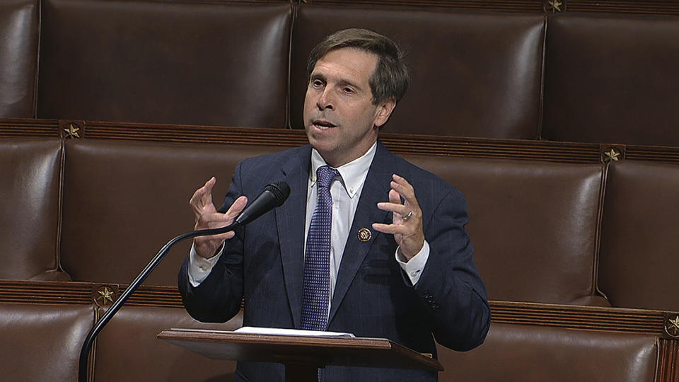 Rep. Chuck Fleischmann gestures with his hands while speaking into a microphone