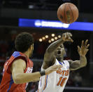 Florida forward Dorian Finney-Smith (10) passes the ball by Dayton forward Devin Oliver (5) during the first half in a regional final game at the NCAA college basketball tournament, Saturday, March 29, 2014, in Memphis, Tenn. (AP Photo/Mark Humphrey)