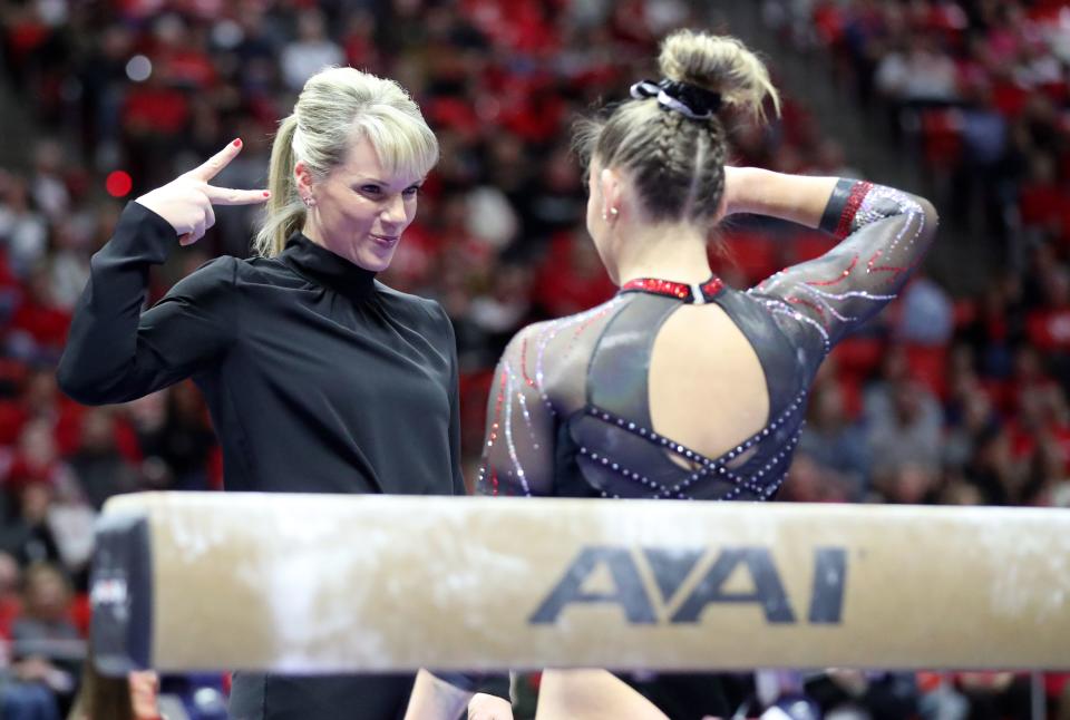 Utah gymnastics head coach Carly Dockendorf does a special handshake with Makenna Smith before Smith’s beam routine as the Utah Red Rocks compete against Oregon State in a gymnastics meet at the Huntsman Center in Salt Lake City on Friday, Feb. 2, 2024. Utah won. | Kristin Murphy, Deseret News