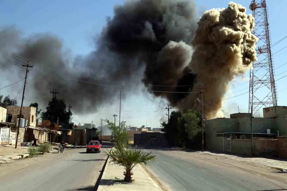 Smoke rises from a burning house during clashes between members of Iraqi Shiite group known as Hashd al Shaabi (the Popular Crowd) and Kurdish groups in Tuz, southern Kirkuk city, Iraq, Oct. 17, 2017. Iraqi military forces launched operations against Kurdish forces around Kirkuk early on Oct. 16, 2017, and took control of the largest oil fields in the disputed city after Kurdish forces withdrew. (Photo: Bareq al-Samarrai/EPA-EFE/REX/Shutterstock)