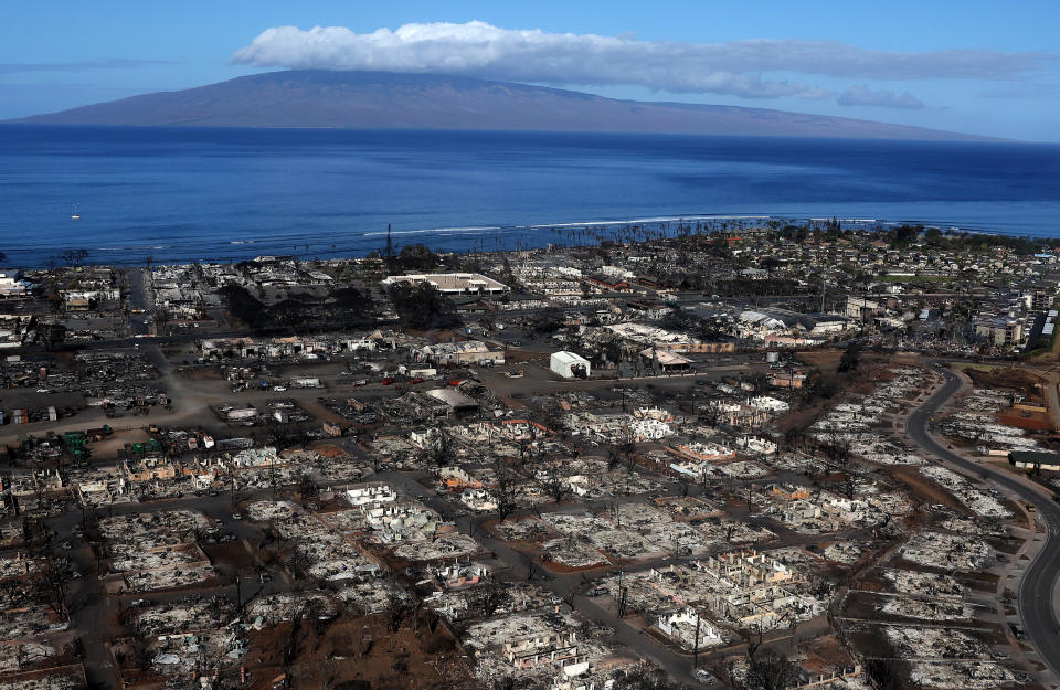 LAHAINA, HAWAII - AUGUST 11: In an aerial view, homes and businesses are seen that were destroyed by a wildfire on August 11, 2023 in Lahaina, Hawaii. Dozens of people were killed and thousands were displaced after a wind-driven wildfire devastated the town of Lahaina on Tuesday. Crews are continuing to search for missing people. (Photo by Justin Sullivan/Getty Images)