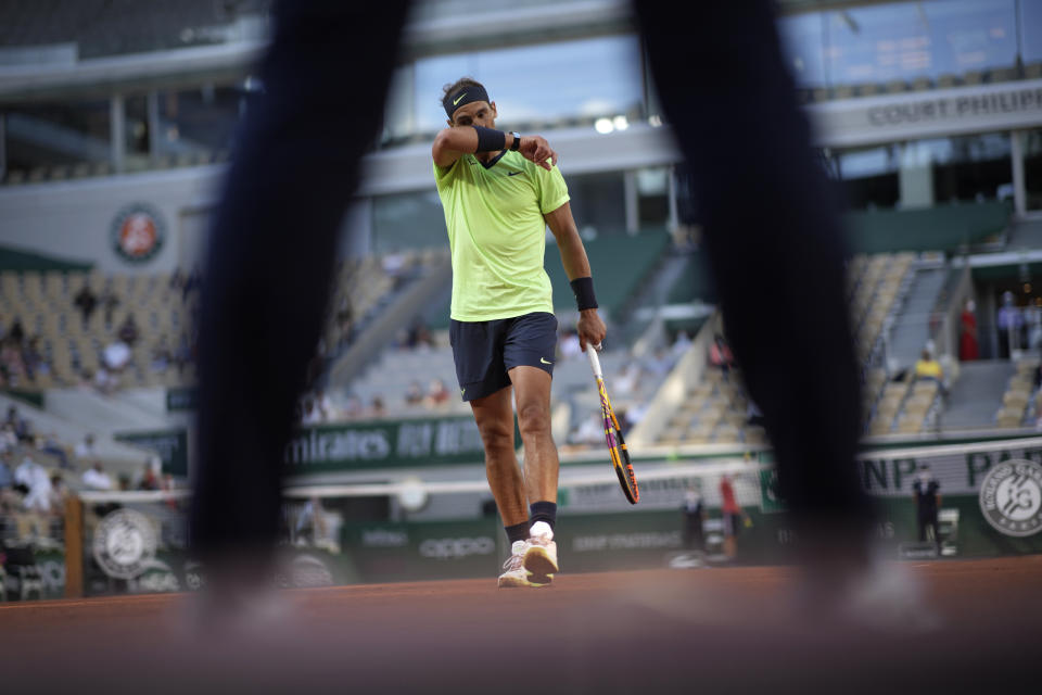 Spain's Rafael Nadal walks back to the service line as he plays against Italy's Jannik Sinner during their fourth round match on day 9, of the French Open tennis tournament at Roland Garros in Paris, France, Monday, June 7, 2021.(AP Photo/Christophe Ena)