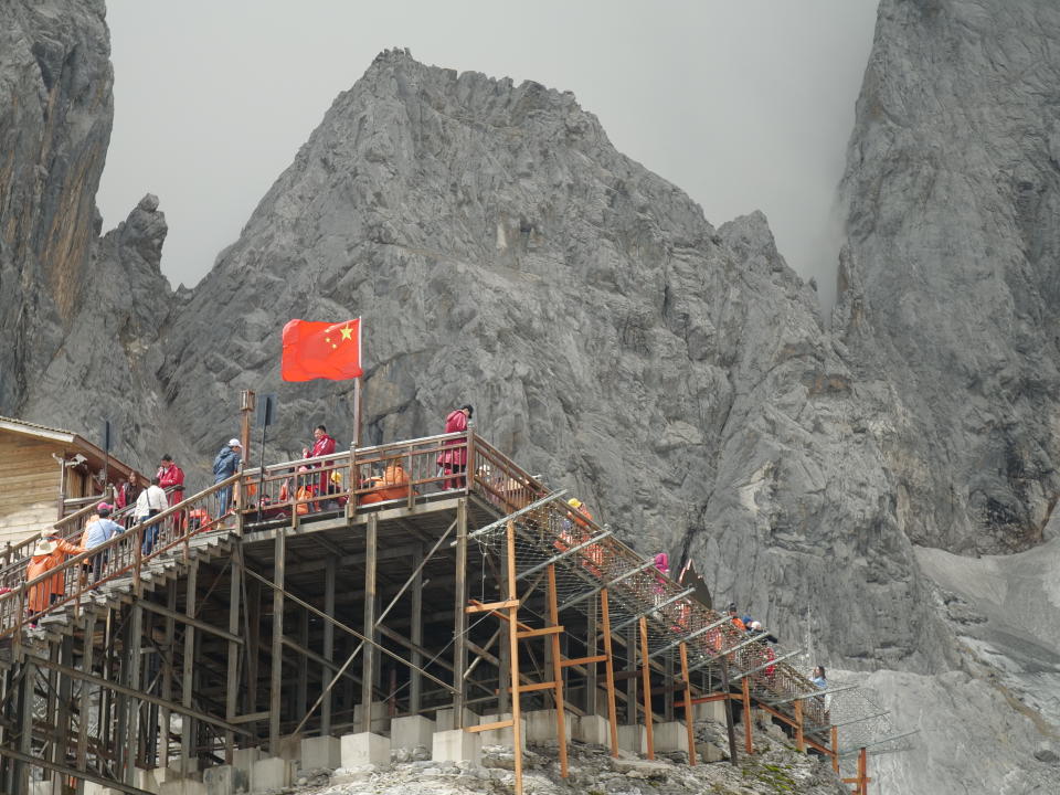 This Sept. 22, 2018 photo shows tourists visiting the Baishui Glacier No.1 atop of the Jade Dragon Snow Mountain in the southern province of Yunnan in China home. Scientists say the glacier is one of the fastest melting glaciers in the world due to climate change and its relative proximity to the Equator. It has lost 60 percent of its mass and shrunk 250 meters since 1982. (AP Photo/Sam McNeil)