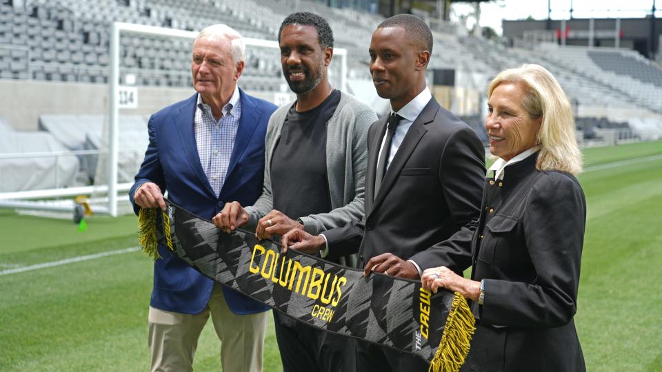 Jun 7, 2024; Columbus, Ohio, USA; The Columbus Crew introduced Issa Tall (third from left) as their new General Manager at Lower.com Field Friday afternoon June 7, 2024. They stood with a Crew scarf after the news conference. From left is team owner Jimmy Haslam, coach Wilfred Nancy, Tall and owner Dee Haslam. Mandatory Credit: Doral Chenoweth-USA TODAY Sports