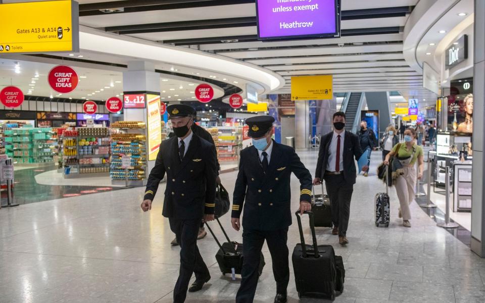 Aircrew in masks in the departure lounge make their way to the aircraft - Geoff Pugh for The Telegraph