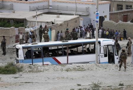 Afghan security personnel stand at the site of a suicide attack in Kabul May 26, 2014. REUTERS/Mohammad Ismail