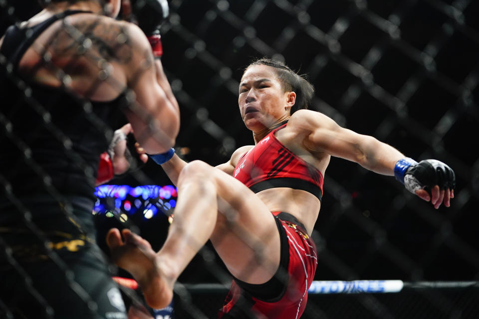 China's Zhang Weili, left, kicks Carla Esparza during the second round of a women's strawweight title bout at the UFC 281 mixed martial arts event, Saturday, Nov. 12, 2022 in New York. Zhang stopped Esparza with a rear neck choke in the second round. (AP Photo/Frank Franklin II)