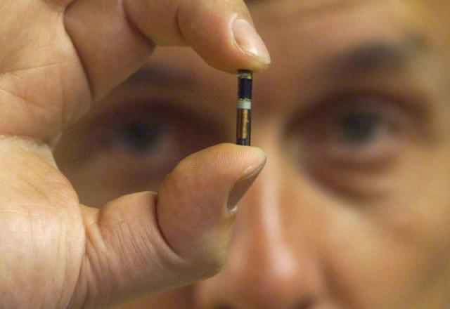 Professor Kevin Warwick holds a microchip August 26, similar to the one implanted into his arm.