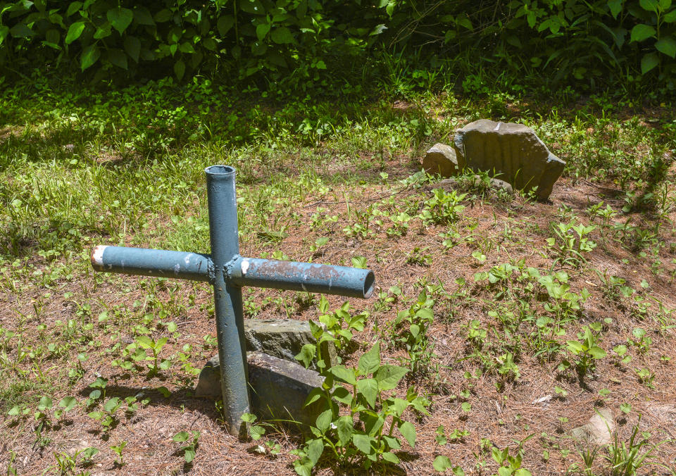 FILE - The gravesite of Harry Trump lies at the edge of a hayfield near the Trump-Lilly Farm in New River Gorge National Park and Preserve in Hinton, W.Va., June, 21, 2022. The sprawling economic package passed by the U.S. Senate this week has a certain West Virginia flavor. The bill could be read largely as an effort to help West Virginia look to the future without turning away entirely from its roots. (Kenny Kemp/Charleston Gazette-Mail via AP, File)