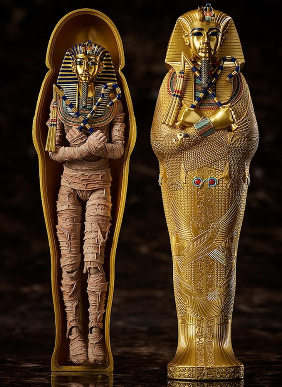 A king tut action figure inside its sarcophagus with the lid open next to the lid itself