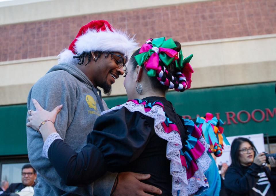 A member of the Notre Dame football team dances with one of the folkolorico dancers greeting the team Sunday afternoon after their arrival in El Paso at the Marriott hotel for the Sun Bowl game.