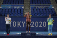 Gold medalist Belinda Bencic, middle, of Switzerland, silver medalist Marketa Vondrousova, left, of the Czech Republic, and bronze medalist Elina Svitolina, of the Ukraine, pose following the women's single matches of the tennis competition at the 2020 Summer Olympics, Sunday, Aug. 1, 2021, in Tokyo, Japan. (AP Photo/Seth Wenig)