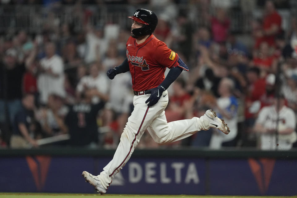 Atlanta Braves' Travis d'Arnaud runs the bases after hitting a home run in the fifth inning of a baseball game against the Texas Rangers Friday, April 19, 2024, in Atlanta. (AP Photo/John Bazemore)