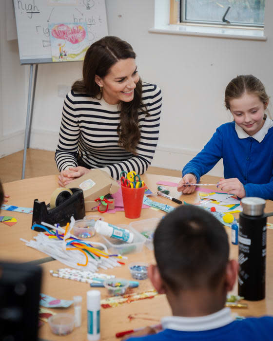 kate middleton at a primary school wearing a breton top and gold hoops