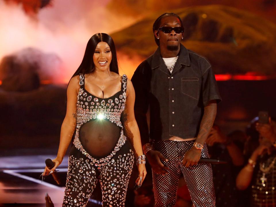 A pregnant Cardi B stands next to Offset on stage at BET Awards.