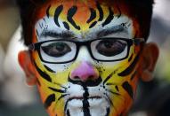 <p>An Indian student with his face painted as a tiger interacts with his classmates as he awaits for the judgement of a face painting competition at the Kids for Tigers Annual Tiger Fest in Mumbai on February 4, 2016. The annual fest in its 15th year aims to bring out the vital connection between the survival of the tiger and the ecological security of the Indian subcontinent. Through ‘edutainment’ workshops, tiger fests, nature walks, film shows and tiger information kits, Kids for Tigers seeks to increase awareness among children about India’s biodiversity and sensitize them to the fact that saving tigers and their forests will also secure our water supply and help save ourselves. </p>