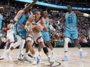 Denver Nuggets forward Aaron Gordon, front, drives to the rim as, from back left, Phoenix Suns forward Mikal Bridges, guard Chris Paul and center Deandre Ayton defend in the first half of an NBA basketball game, Sunday, Dec. 25, 2022, in Denver. (AP Photo/David Zalubowski)