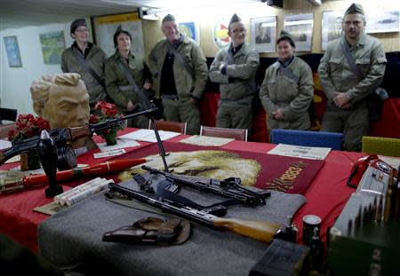 Participants dressed as NVA soldiers look at weapons during the 'reality event' one night at the 'Bunker-Museum' in Rennsteighoehe near the eastern city of Ilmenau October 12, 2013. REUTERS/Ina Fassbender