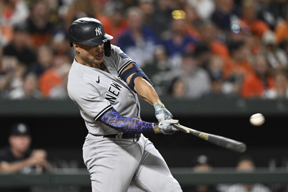 New York Yankees' Giancarlo Stanton connects for a single against the Baltimore Orioles in the fifth inning of a baseball game Sunday, July 30, 2023, in Baltimore. (AP Photo/Gail Burton)