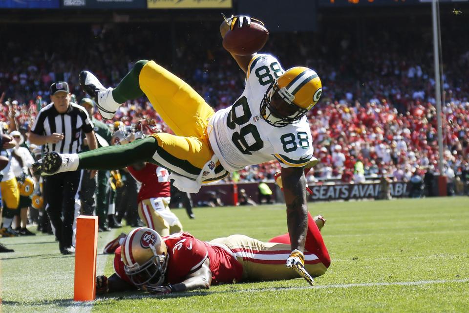 Green Bay Packers tight end Jermichael Finley (88) leaps for a touchdown during the second quarter of his NFL season home opener football game against the San Francisco 49ers in San Francisco, California September 8, 2013. REUTERS/Stephen Lam (UNITED STATES - Tags: SPORT FOOTBALL)