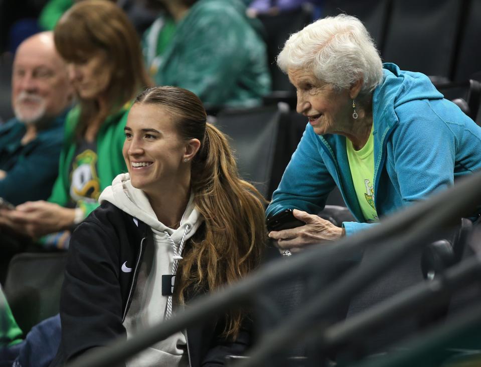 Two legends in Oregon athletic history, Sabrina Ionescu, left, and Becky Sisley watch the Duck women’s basketball team play Southern Oregon at Matthew Knight Arena Oct. 29, 2023 in Eugene, Oregon.