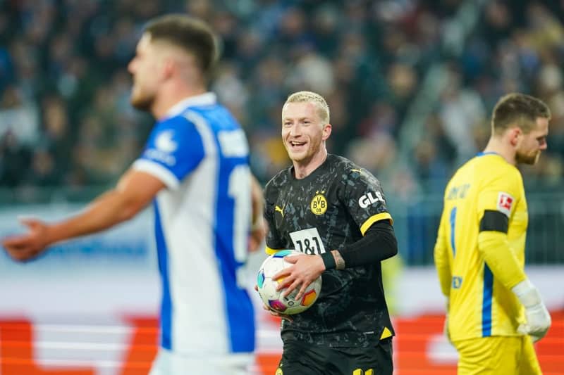 Dortmund's Marco Reus (C) celebrates after scoring his side's second goal of the game during the German Bundesliga soccer match between Darmstadt 98 and Borussia Dortmund at Merck Stadium. Uwe Anspach/dpa
