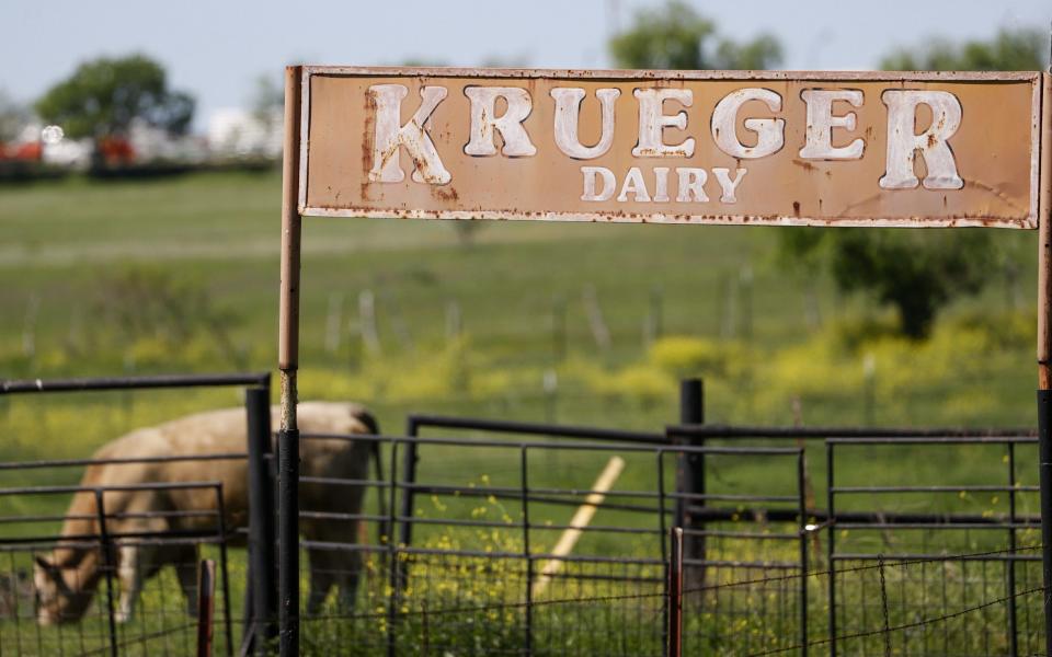 A sign stands on a fence a cattle farm in Austin, Texas, USA