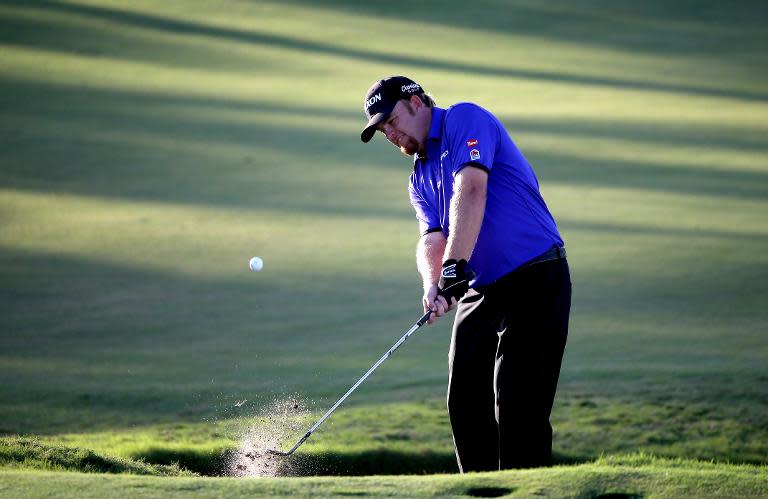 J. B. Holmes of the United States chips a shot out of the bunker on the sixteenth hole during the second round of the World Golf Championships-Cadillac Championship on March 6, 2015 in Doral