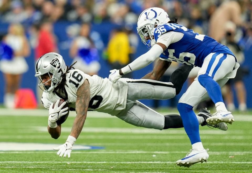 Indianapolis Colts cornerback Chris Lammons (35) dives after Las Vegas Raiders wide receiver Jakobi Meyers (16) on Sunday, Dec. 31, 2023, during a game against the Las Vegas Raiders at Lucas Oil Stadium in Indianapolis.