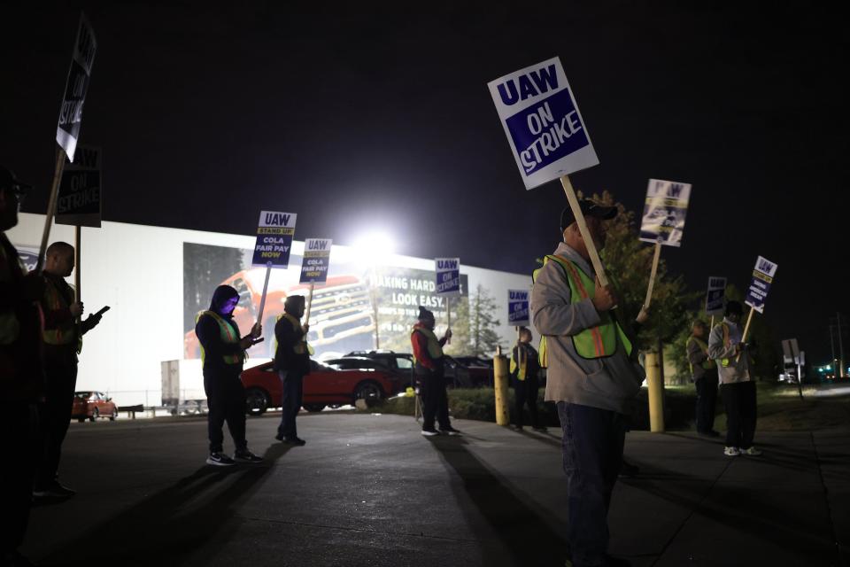 Factory workers and UAW union members form a picket line outside the Ford Motor Co. Kentucky Truck Plant in the early morning hours on Oct. 12, 2023 in Louisville, Kentucky. UAW leadership announced that the Kentucky Truck Plant would be the latest automotive manufacturing facility to join the nationwide strike.