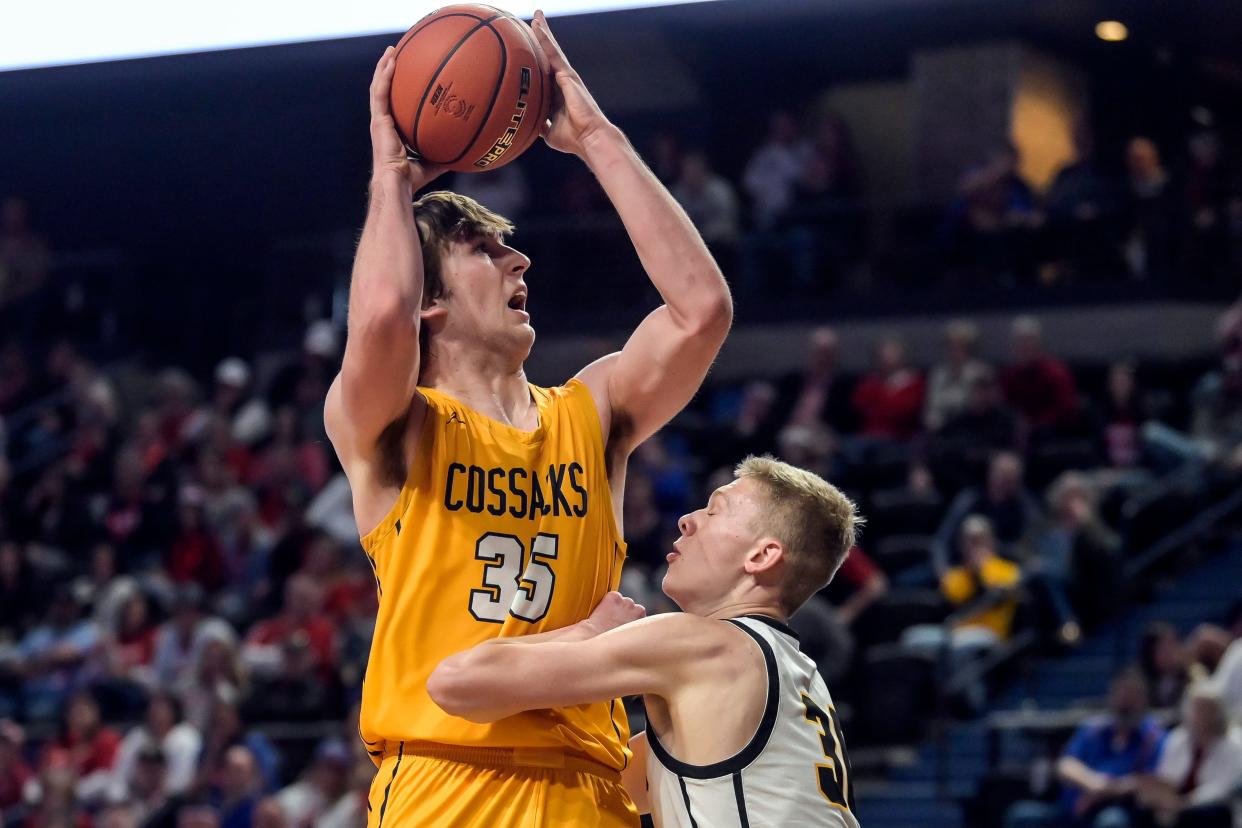 Sioux Valley's Alec Squires (35) shoots over top of Groton's Gage Sippel (30) during their consolation semifinal game in the state Class A boys basketball tournament on Friday, March 15, 2024 in the Summit Arena at The Monument in Rapid City. Sioux Valley won 67-58.